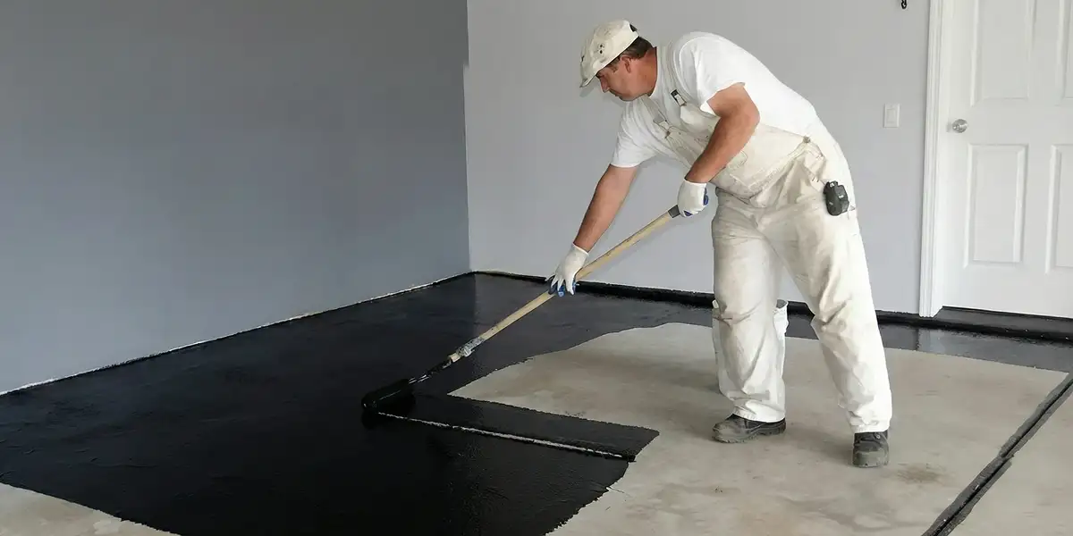 basement waterproofing professional applying waterproof coating to protect a basement floor in Orlando, FL
