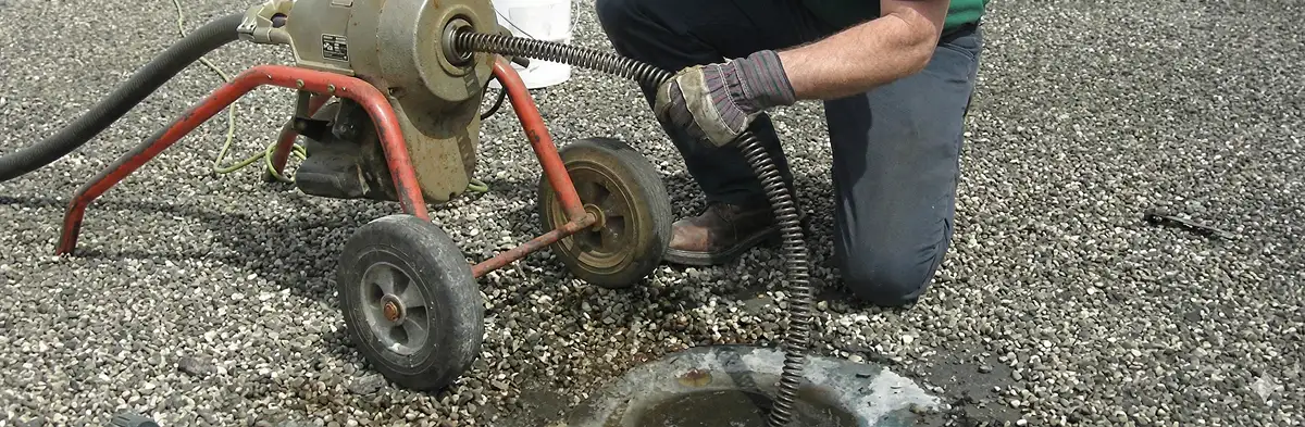 sewer rodding technician actively removing blockages from a sewer line in Orlando, FL